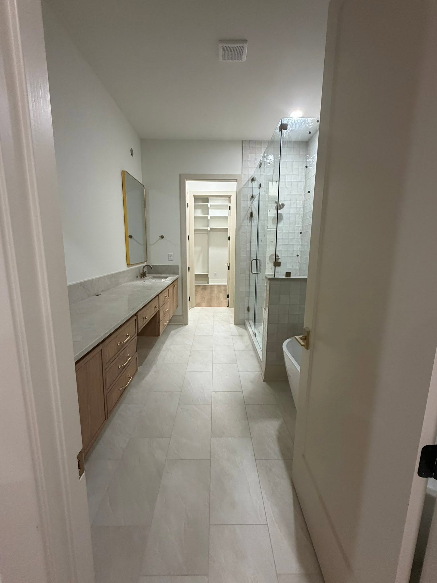 Final clean — modern bathroom with vanity, shower, and tile flooring